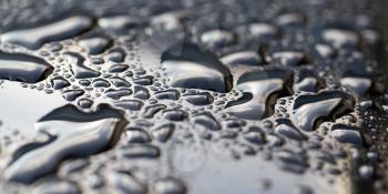 drops of water on a dark car