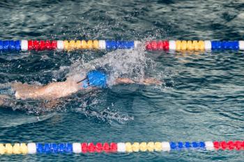 boy goes in for sports in the pool