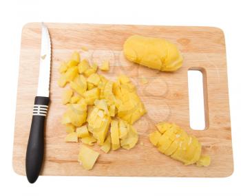 Chef cuts boiled potatoes on board on a white background