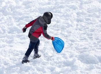 child riding a roller coaster in the winter