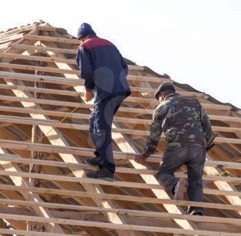 workers working on the roof . A photo