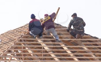 workers working on the roof . A photo