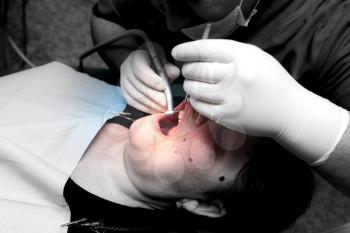 The dentist works with the client in the clinic .