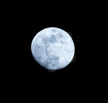 Blue moon on a black background at night .