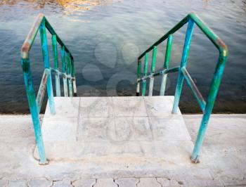 Stairs to the water of the swimming pool .