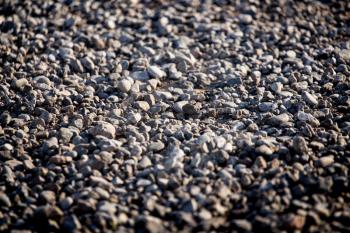 Crushed stone on the road as a background .