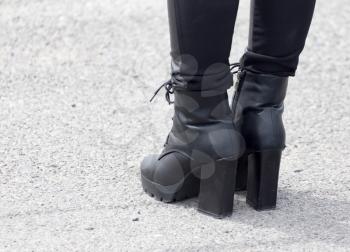 Legs of a girl in black heels .