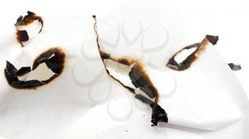 Trail of burnt paper on white background .