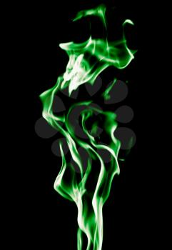 Green flame of fire on a black background .
