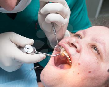 The dentist works with the client in the clinic .