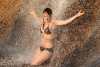 Royalty Free Photo of a Girl in a Bikini at a Waterfall