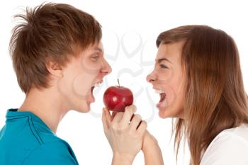 Royalty Free Photo of Two Teenagers Biting an Apple