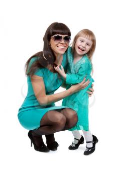 Fashionable Mom and young daughter hugging. Isolate on white background