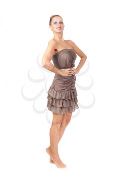 Charming slim girl in a brown dress in the studio on a white background