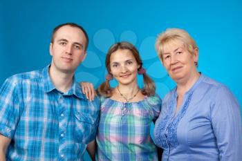 Happy family in the studio on blue background