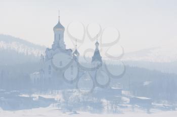 The Orthodox church with golden domes in the fog