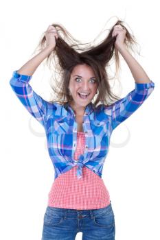 Beautiful girl madly pulling at his hair in the studio on a white background