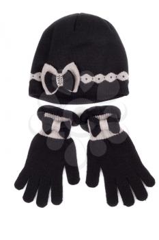 Set of pairs of gloves and knit hat on a white background
