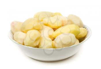Peeled potatoes on plate, isolated on white background.