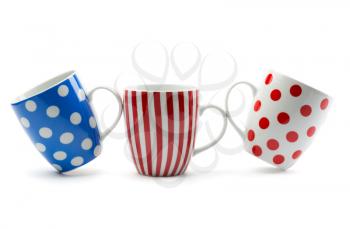 Three porcelain cup with stripes and dots. Isolate on white.