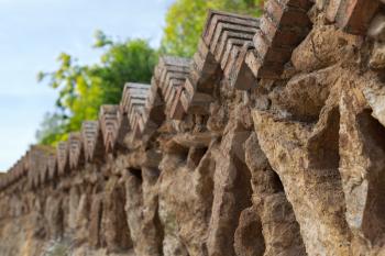 Fence of old stones in a park in Barcelona, ​​Spain.
