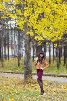 Slim happy woman in the autumn forest, full length portrait