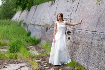 girl in white dress at the concrete wall