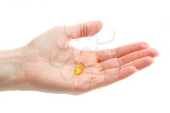 Omega 3 pill in the women hand. Isolate on white.