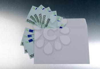 Euro banknotes in envelope over a metall background