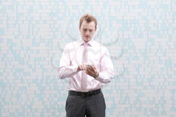 Royalty Free Photo of a Businessman Checking His Phone