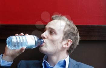 Royalty Free Photo of a Businessman Drinking Water
