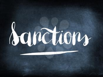 Sanctions handwritten on a chalkboard