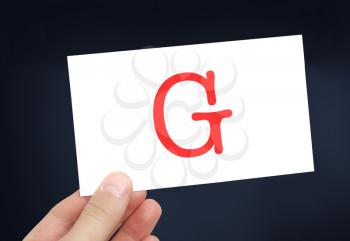 The letter G on a card