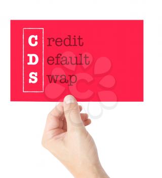 Credit Default Swap explained on a card held by a hand