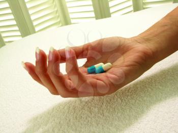 Royalty Free Photo of a Hand Holding Pills