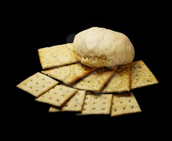 fresh bread and crackers on black background