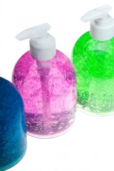 colorfull blue,pink and green hair gel bottles over white background