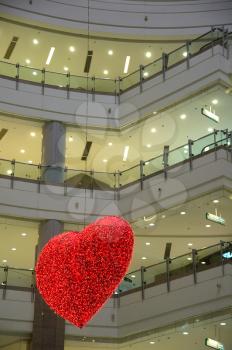 heart shaped light hanging on a shopping mall ceiling