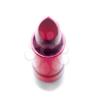 vivid red lipstick tube over white background