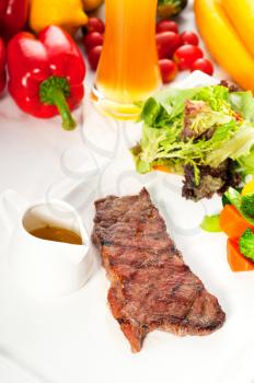 juicy BBQ grilled rib eye ,ribeye steak ,vegetables and lagher beer on background ,MORE DELICIOUS FOOD ON PORTFOLIO