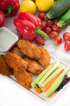 classic  buffalo chicken wings served with fresh pinzimonio and vegetables on background,MORE DELICIOUS FOOD ON PORTFOLIO