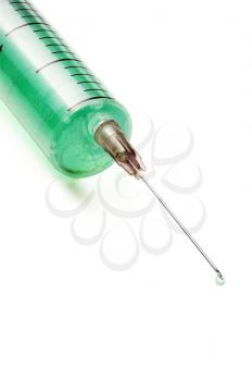 syringe filled with green liquid over white background