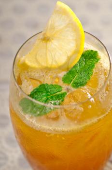 refreshing Ice tea closeup macro with lemon and mint leaves