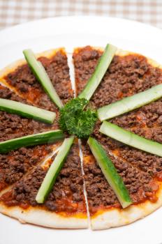 fresh baked Turkish beef pizza with cucumber on top