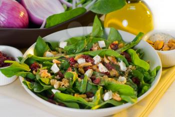 plate of fresh colorfull spinach salad close up