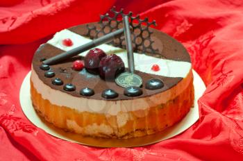 chocolate birthday cake over red fabric background