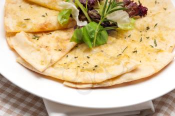 fresh healthy garlic pita bread pizza with salad on top