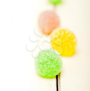 sugar jelly fruit candy over white wood table