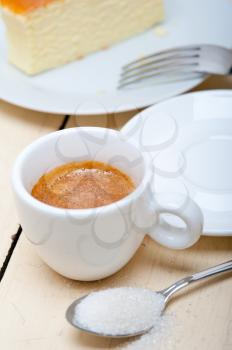 italian espresso coffee and cheese cake over white wood table