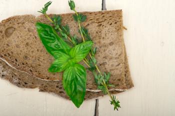 rustic Italian bread basil and thyme simple snack on white wood table